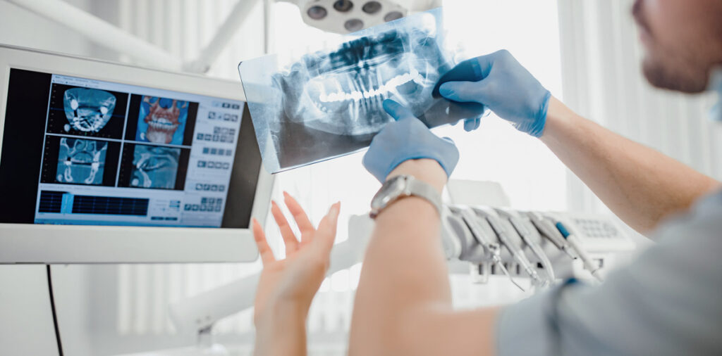 dentist showing x ray to patient