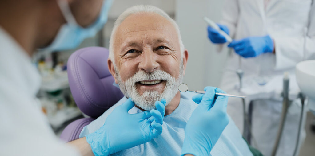 man smiling at dentists procedure